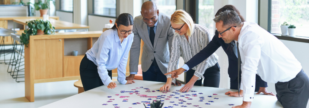 benefits of learning through play for adults, business team figuring out puzzle