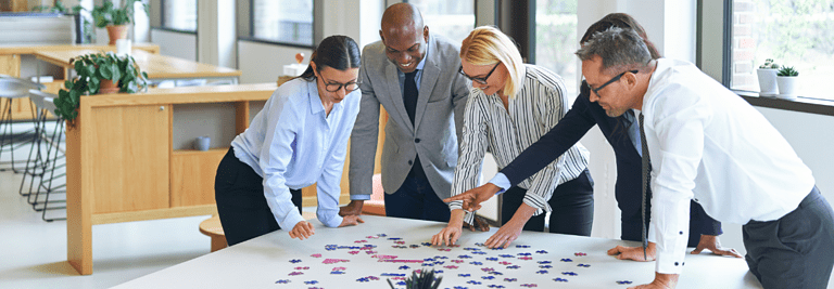benefits of learning through play for adults, business team figuring out puzzle