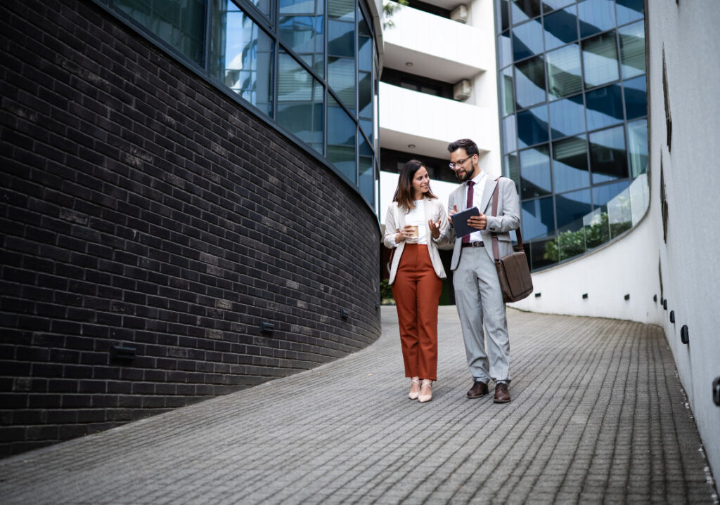 practice business and workplace skills, coworkers discussing business while walking